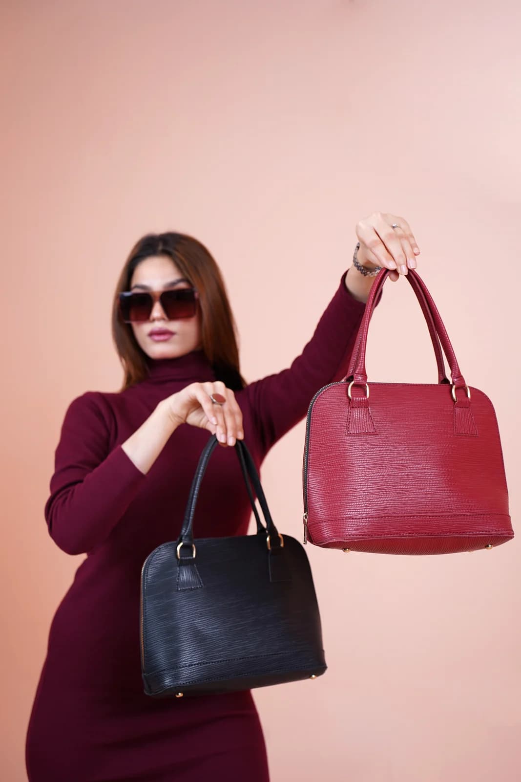 Model holding handbags in a fashion image
